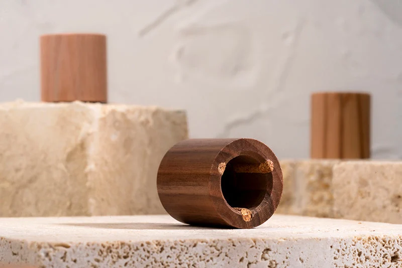 Luxury wooden cap displayed on textured stone blocks