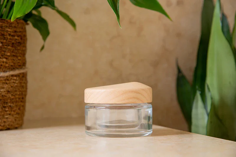 Clear glass jar with a sculpted wooden cap
